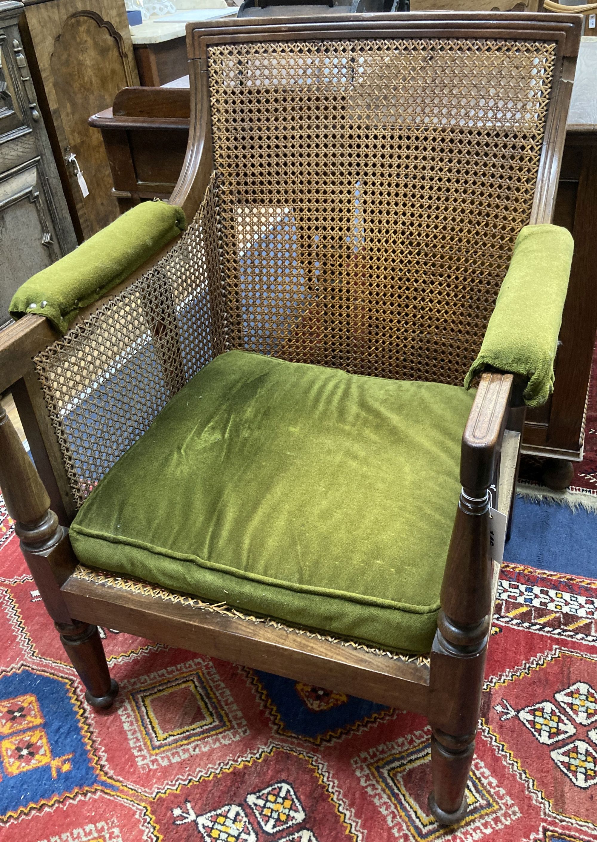 A Regency mahogany bergere armchair, width 67cm, depth 64cm, height 92cm